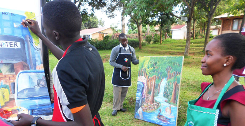 Nansambu looks as a student paints